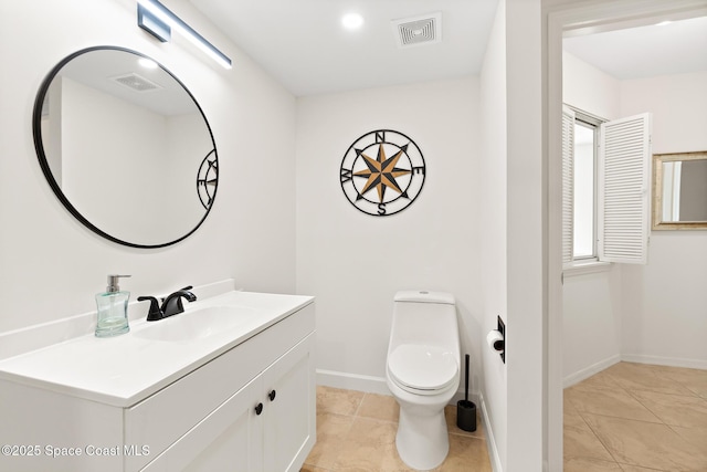 bathroom with toilet, baseboards, visible vents, and vanity