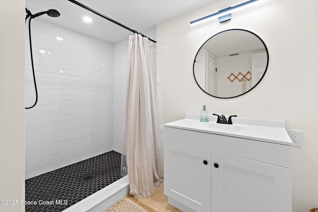 bathroom featuring a stall shower, recessed lighting, and vanity