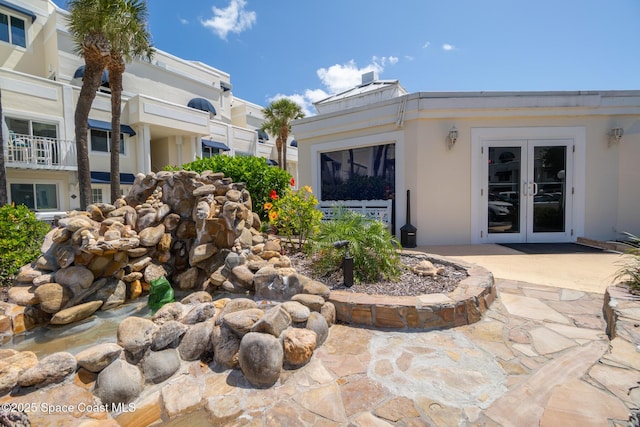 doorway to property with french doors and stucco siding