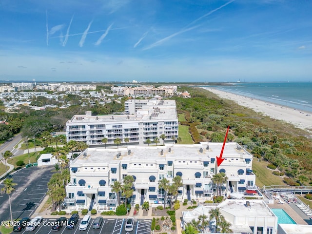 drone / aerial view with a beach view and a water view