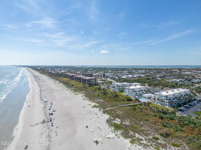 aerial view featuring a view of city, a beach view, and a water view