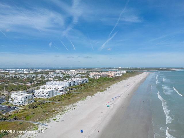 drone / aerial view with a view of the beach, a water view, and a city view