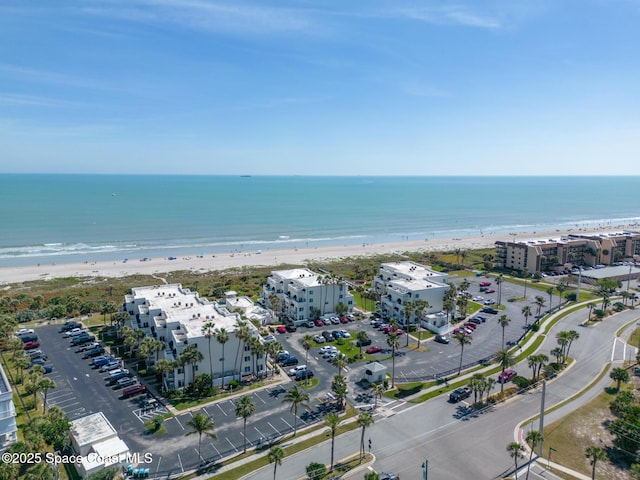 birds eye view of property with a view of the beach and a water view