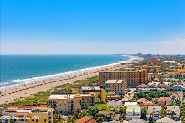 bird's eye view featuring a water view and a beach view