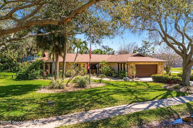 view of front of home featuring a garage and a front lawn