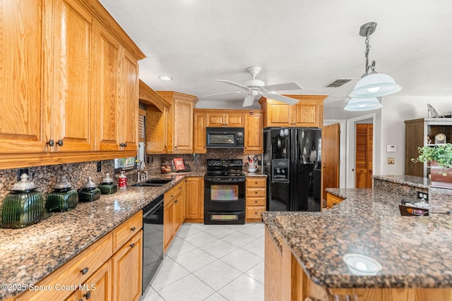 kitchen featuring light tile patterned flooring, a sink, visible vents, black appliances, and tasteful backsplash