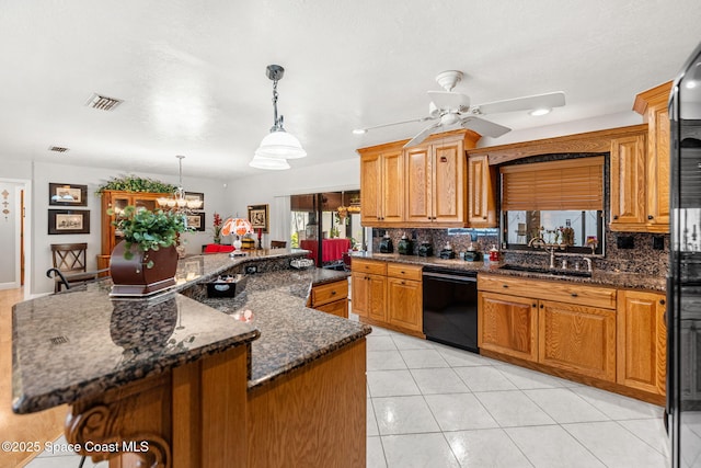 kitchen with tasteful backsplash, visible vents, a sink, and black appliances