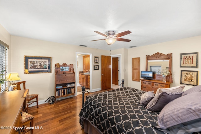 bedroom with dark wood-style floors, ceiling fan, visible vents, and baseboards