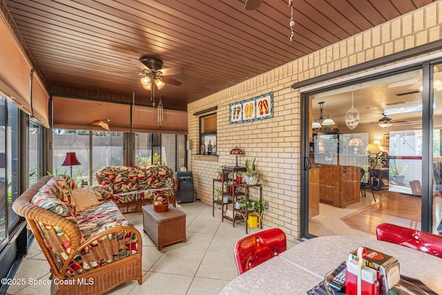 sunroom with a wealth of natural light and a ceiling fan