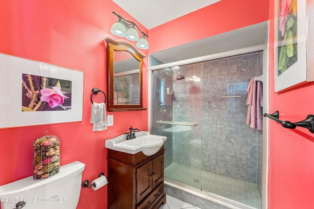 bathroom with toilet, a shower stall, and vanity