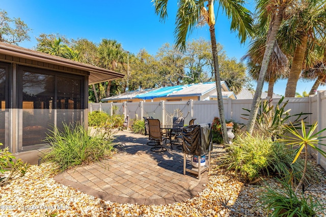 view of patio featuring outdoor dining area and a fenced backyard