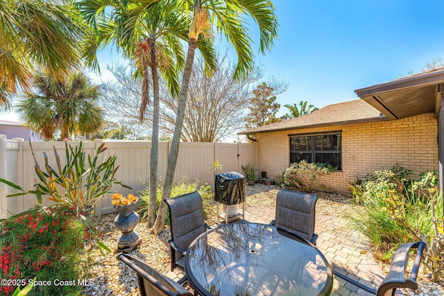 view of patio with outdoor dining space and a fenced backyard