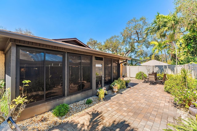 view of patio / terrace featuring a sunroom and a fenced backyard