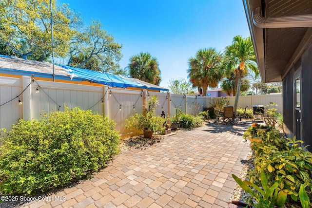 view of patio / terrace with a gate, a fenced backyard, and outdoor dining area