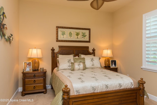 bedroom featuring baseboards and light colored carpet