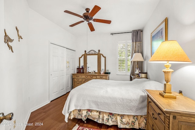 bedroom with a ceiling fan, a closet, baseboards, and wood finished floors