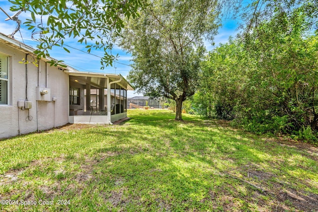 view of yard featuring a sunroom