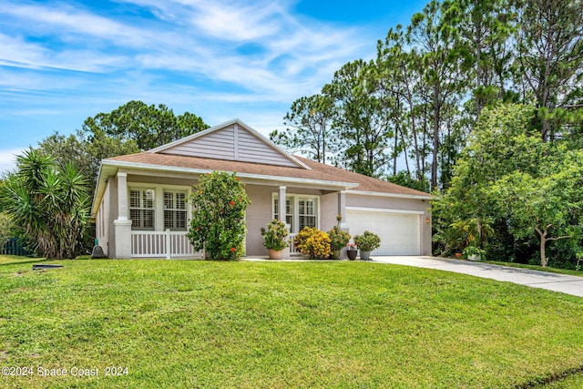 view of front facade with stucco siding, covered porch, a garage, driveway, and a front lawn