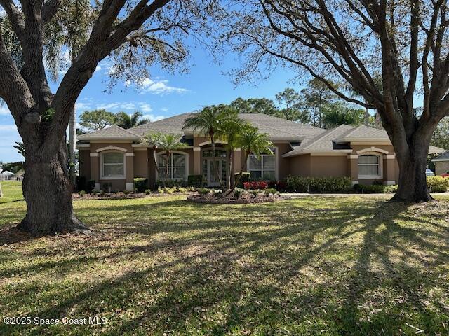 single story home with a front lawn and stucco siding