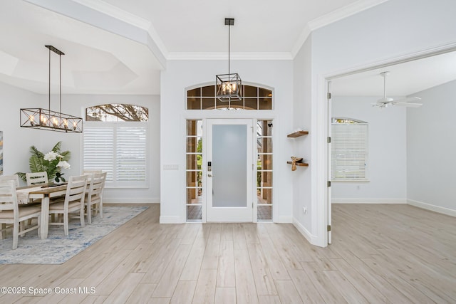 foyer featuring baseboards, a notable chandelier, and wood finished floors