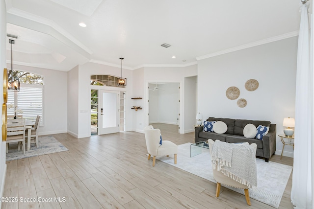 living room featuring recessed lighting, light wood-type flooring, baseboards, and crown molding