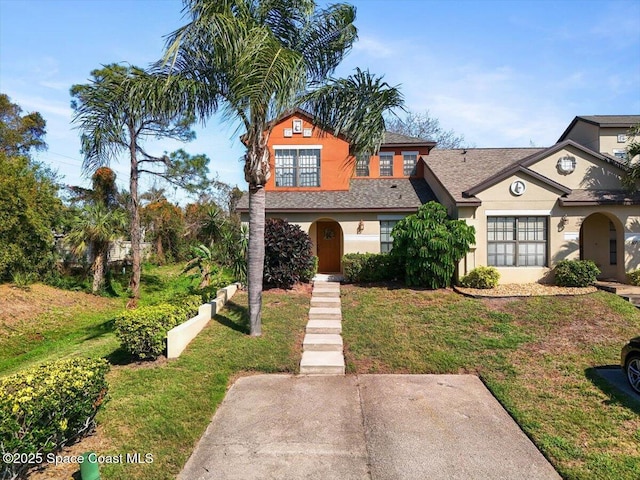 view of front of home featuring a front lawn and stucco siding