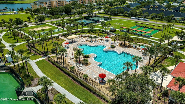 view of pool featuring a water view and a patio area