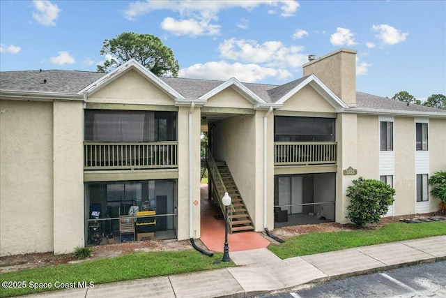 view of property featuring stairs