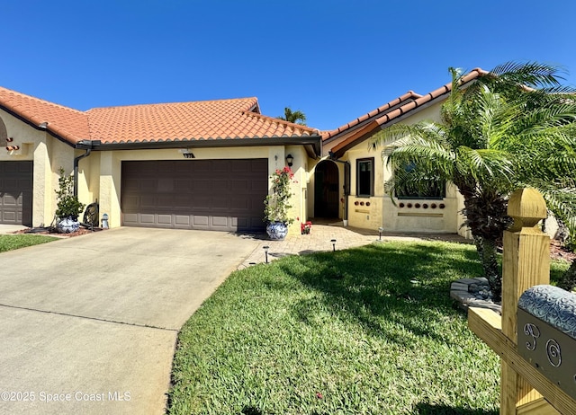 mediterranean / spanish-style house with an attached garage, a front yard, a tile roof, and stucco siding