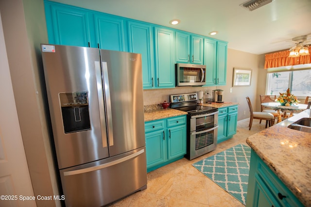 kitchen featuring visible vents, a sink, recessed lighting, stainless steel appliances, and light stone countertops