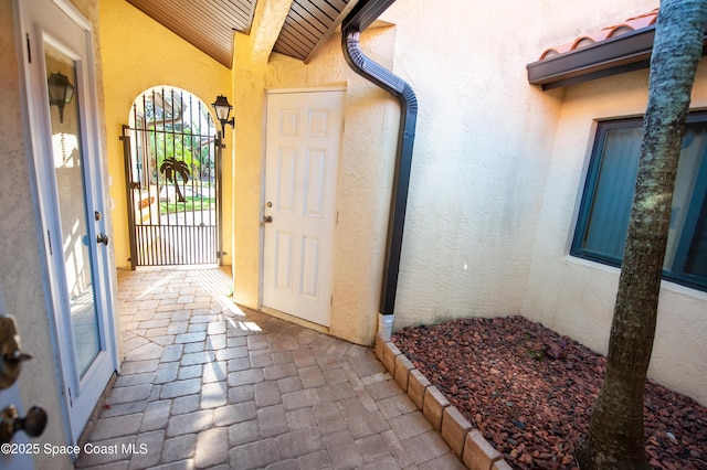 entrance to property featuring stucco siding and a tile roof