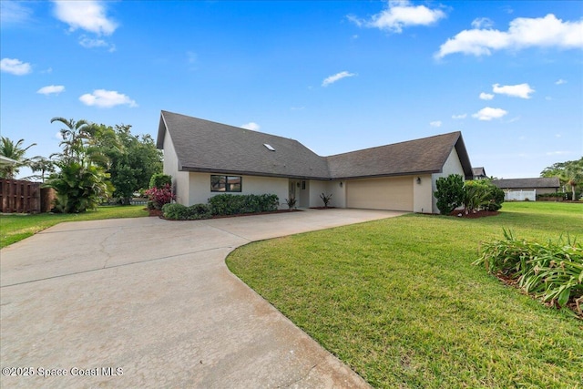 single story home featuring fence, driveway, a garage, stucco siding, and a front lawn