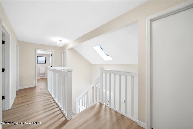 6315 Anchor Ln, Rockledge, FL 32955 - hallway featuring an upstairs landing, wood finished floors, a skylight, and lofted ceiling