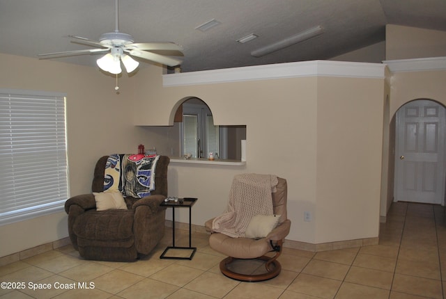 sitting room featuring arched walkways, ceiling fan, lofted ceiling, visible vents, and tile patterned floors