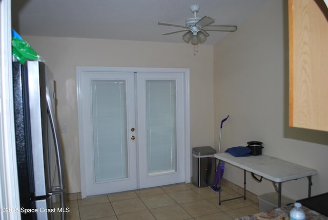 interior space featuring light tile patterned floors, a ceiling fan, and french doors