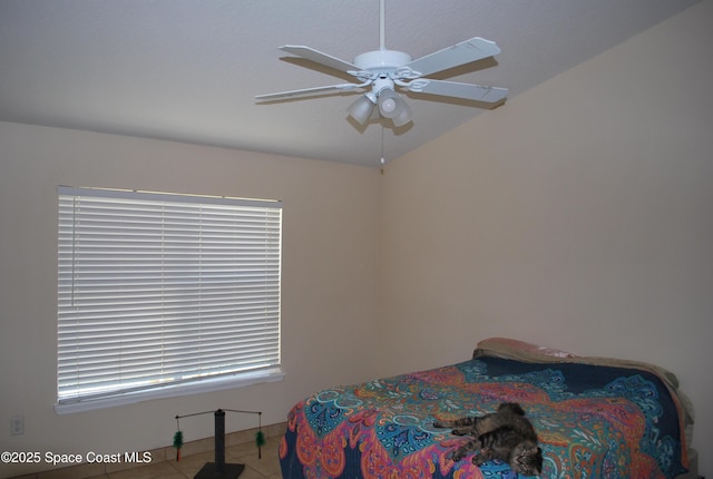 bedroom with ceiling fan and tile patterned floors