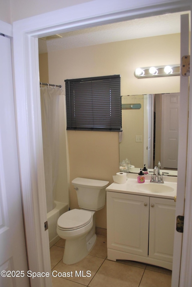 bathroom featuring toilet, tile patterned flooring, shower / bath combo, and vanity