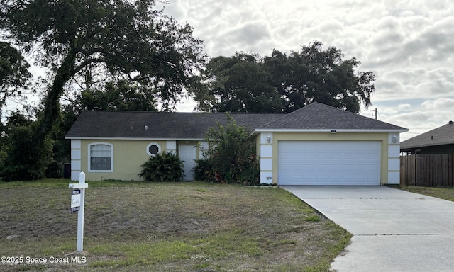 ranch-style house featuring a garage, a front lawn, fence, and driveway