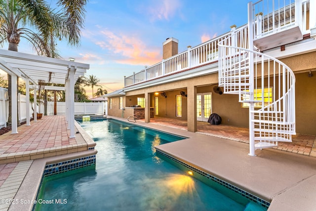 pool at dusk with a patio, a fenced backyard, stairs, french doors, and a pergola