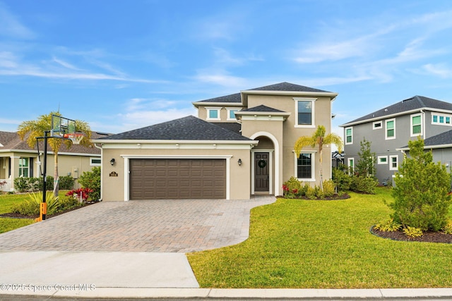 view of front of house featuring an attached garage, stucco siding, decorative driveway, and a front yard