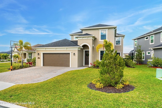 view of front facade with a garage, stucco siding, decorative driveway, and a front yard