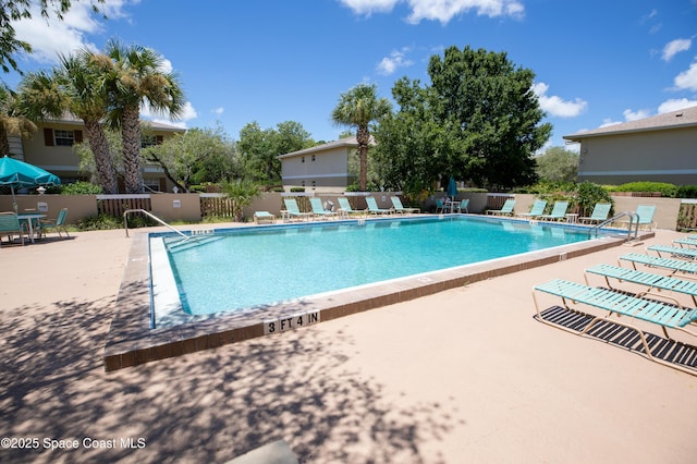 community pool featuring a patio area and fence