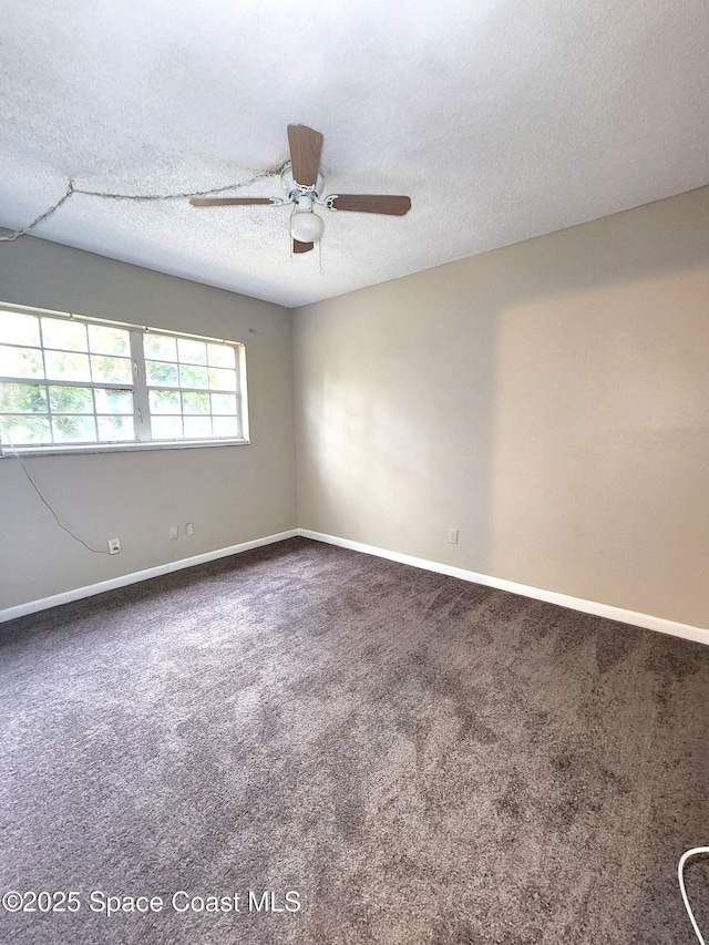 unfurnished room featuring carpet, baseboards, ceiling fan, and a textured ceiling