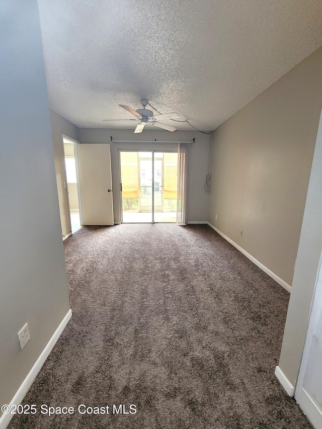 spare room featuring a textured ceiling, carpet floors, ceiling fan, and baseboards