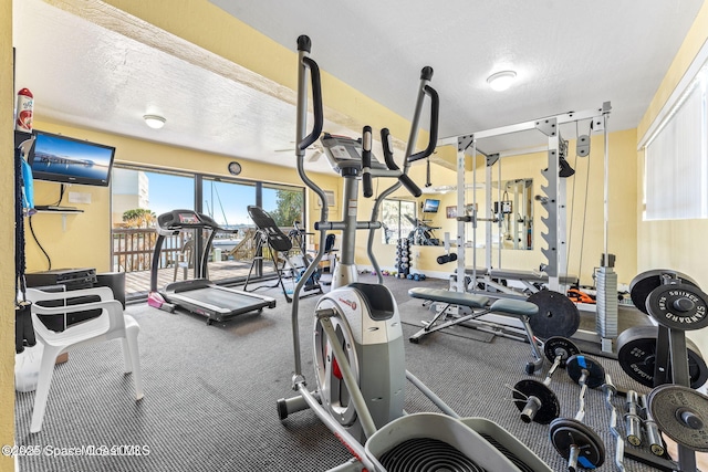 gym featuring a textured ceiling