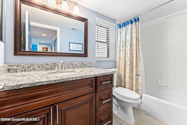 bathroom with shower / bath combination with curtain, visible vents, toilet, vanity, and wood finished floors