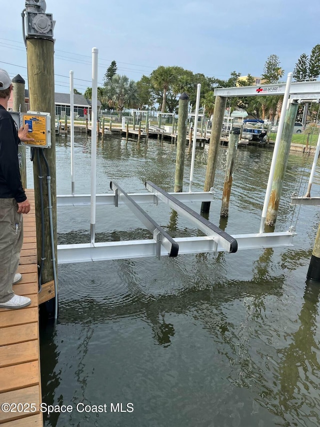 dock area featuring a water view and boat lift