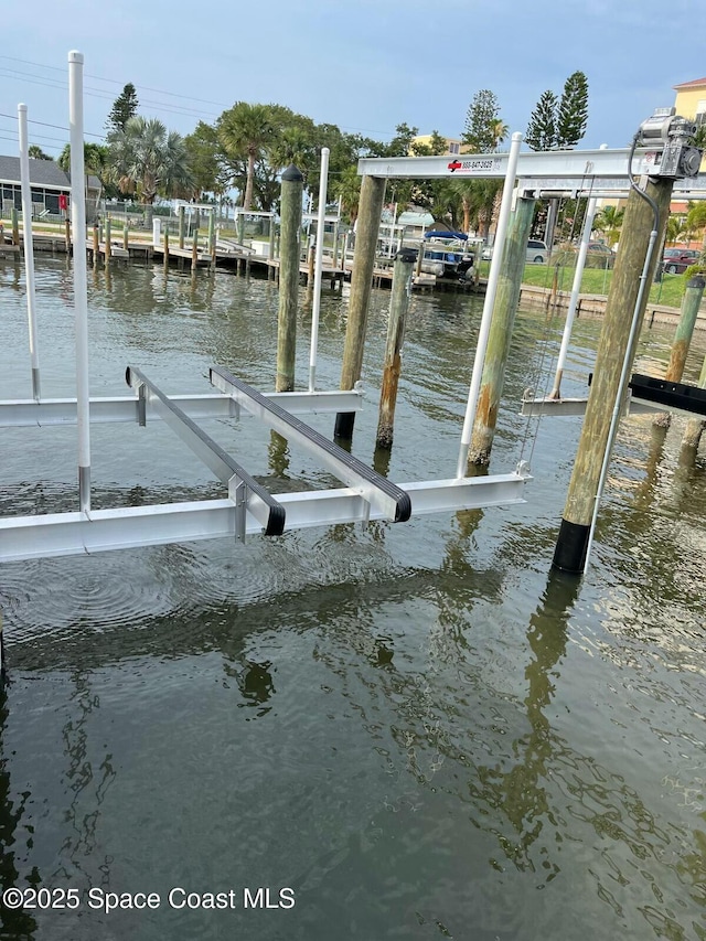 dock area featuring a water view and boat lift