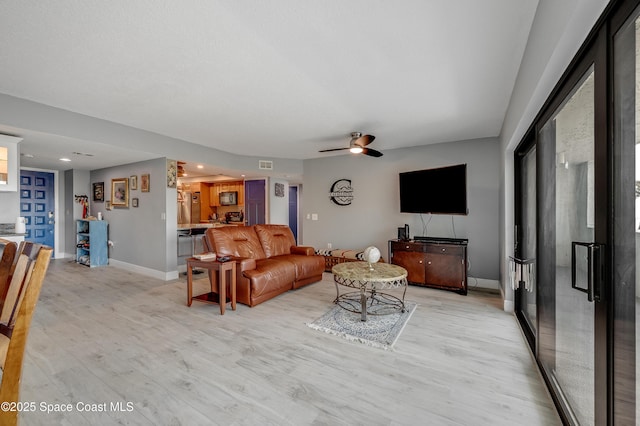 5055 Dixie Hwy NE Unit B206, Palm Bay, FL 32905 - living room with light wood finished floors, ceiling fan, baseboards, and recessed lighting