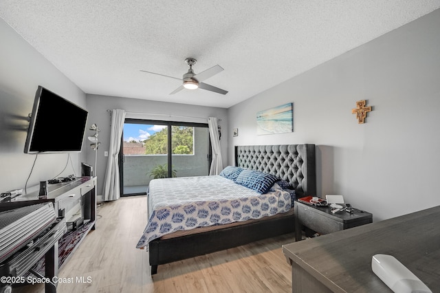 5055 Dixie Hwy NE Unit B206, Palm Bay, FL 32905 - bedroom with access to exterior, light wood-type flooring, a textured ceiling, and ceiling fan